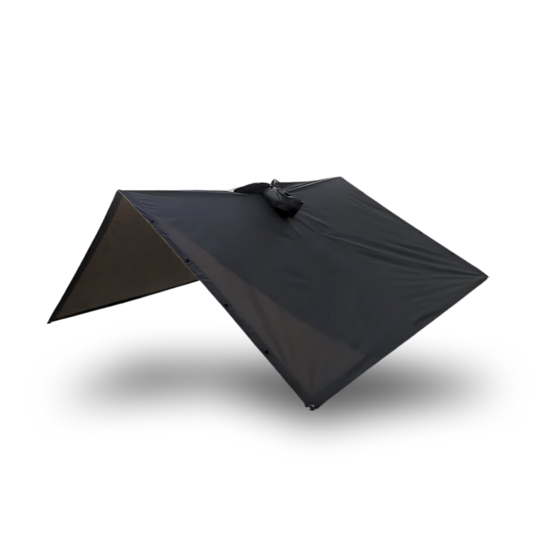 The Australian Trekshield poncho set up as an emergency ultralight tarp shelter using trekking poles, demonstrating a quick shelter solution for Camino pilgrims caught in unexpected weather between stops